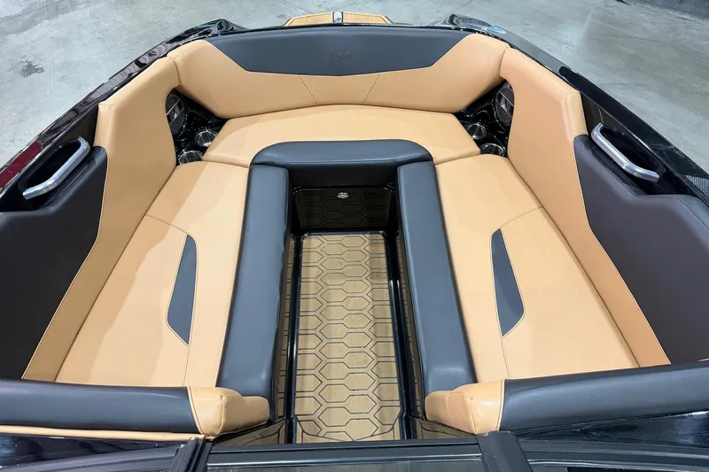 Slide: The Image of 2022 MasterCraft NXT24 boat interior with tan and black seating, hexagonal floor pattern. - 7