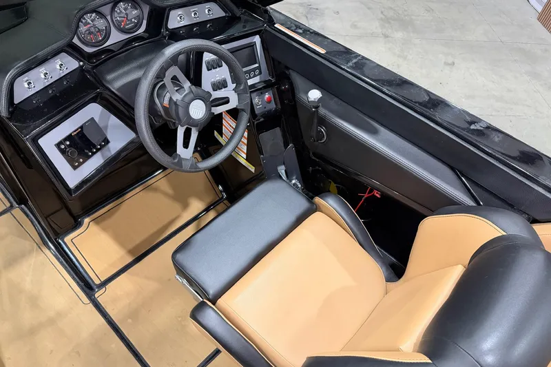 Slide: The Image of 2022 MasterCraft NXT24 boat interior with steering wheel and dashboard controls. - 9