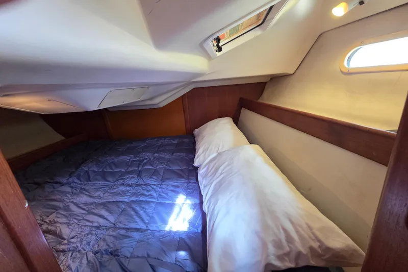 Slide: The Image of Cozy cabin interior of 2003 Hunter 326 sailboat with bed and porthole. - 16