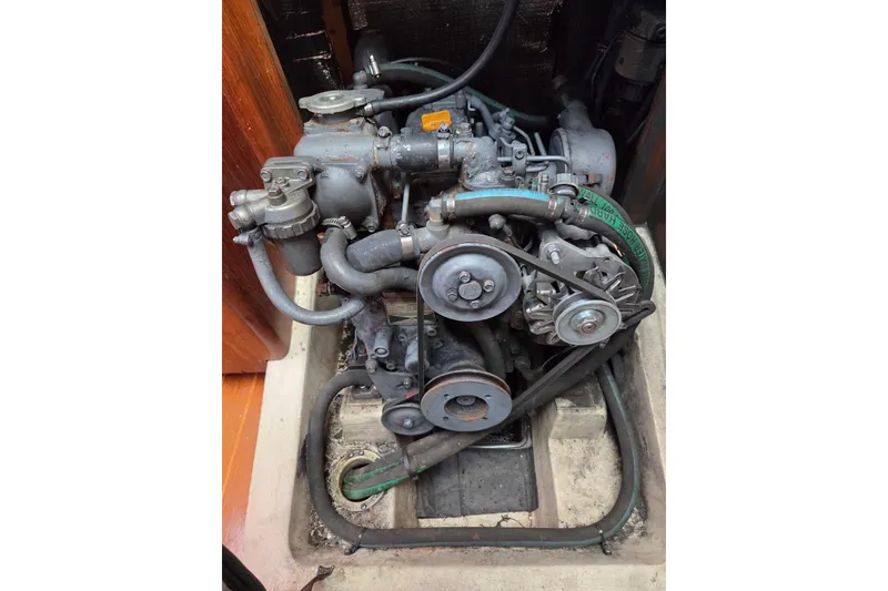 Slide: The Image of 2003 Hunter 326 engine compartment with visible belts and hoses. - 19