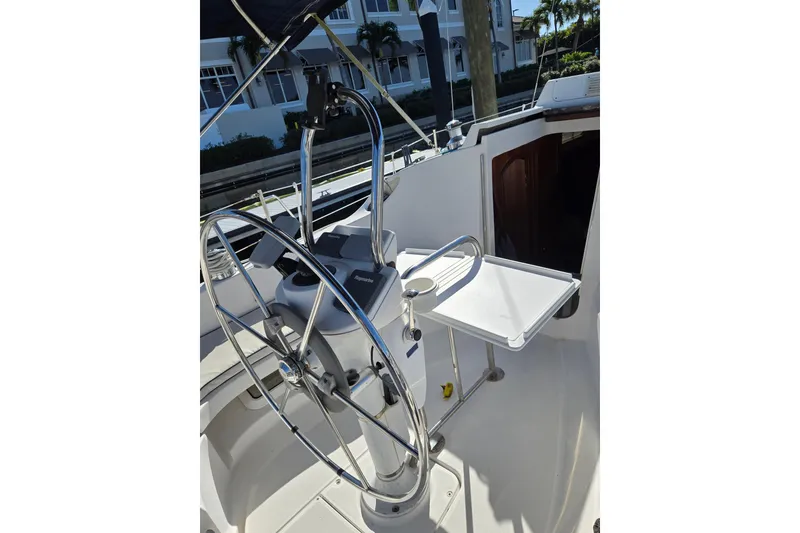 Slide: The Image of 2003 Hunter 326 sailboat cockpit with steering wheel and navigation equipment. - 7