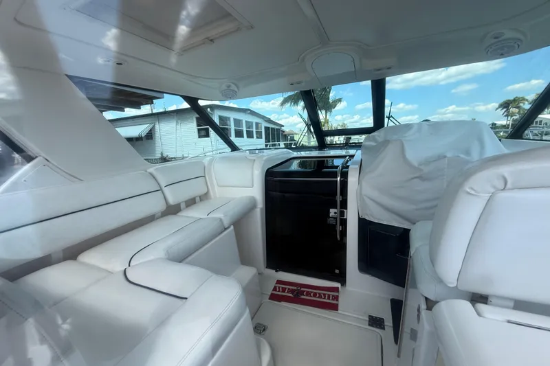 Slide: The Image of Interior of 2004 Tiara Yachts 3600 Sovran with white seating and covered helm. - 11