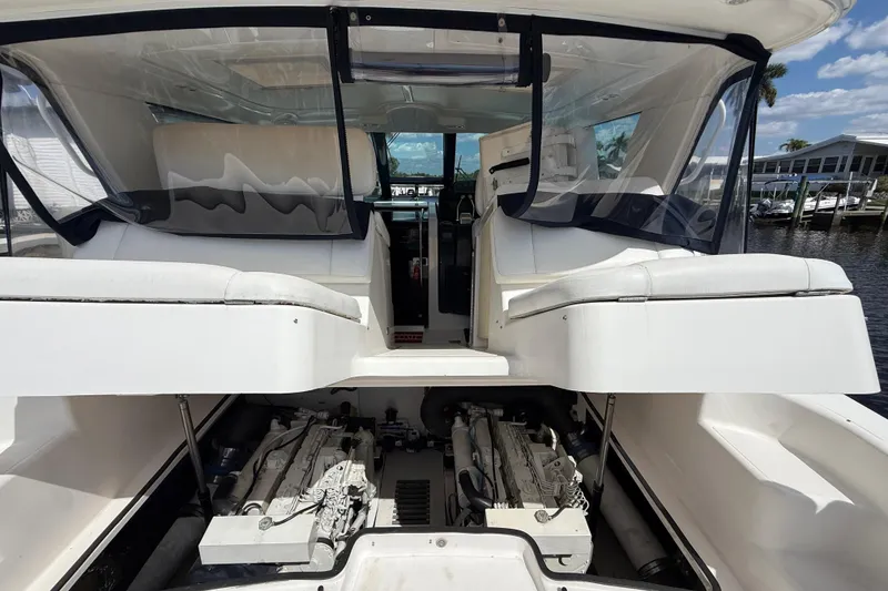 Slide: The Image of 2004 Tiara Yachts 3600 Sovran interior with visible engine compartment and seating area. - 13