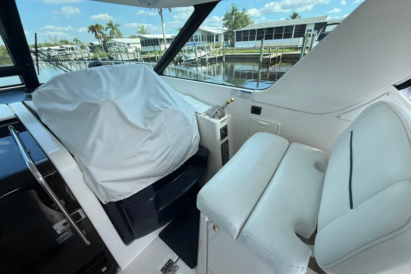 Slide: The Image of 2004 Tiara Yachts 3600 Sovran interior with covered helm and white seating. - 19