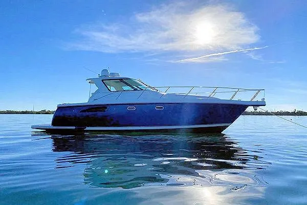 Slide: The Image of 2004 Tiara Yachts 3600 Sovran on calm water under a bright sun. - 2