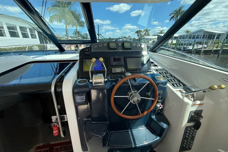Slide: The Image of 2004 Tiara Yachts 3600 Sovran helm with steering wheel and navigation controls. - 20