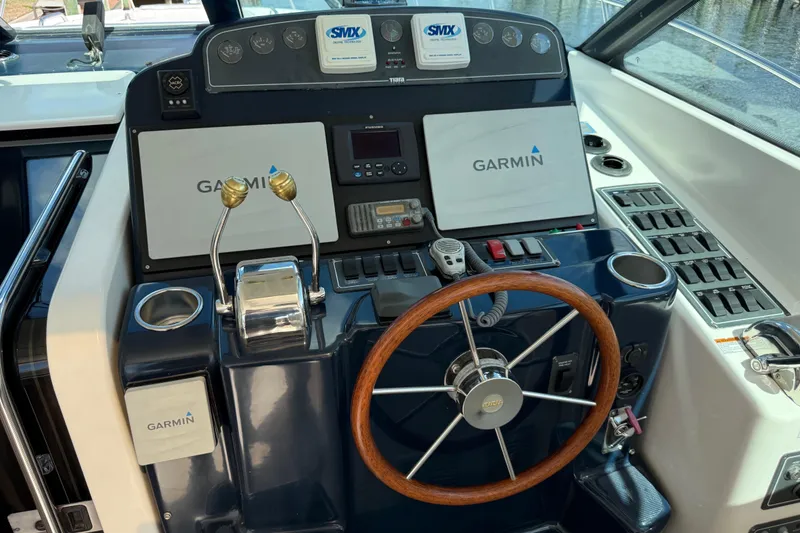 Slide: The Image of Helm of 2004 Tiara Yachts 3600 Sovran with Garmin navigation system and wooden steering wheel. - 22