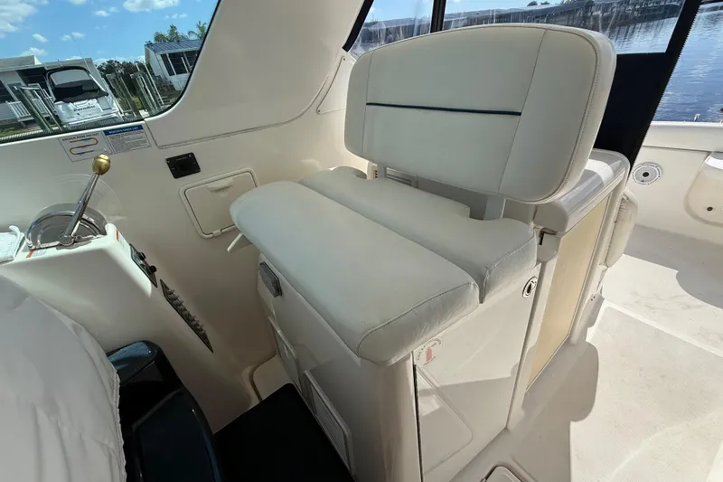 Slide: The Image of 2004 Tiara Yachts 3600 Sovran helm seat with control panel, overlooking marina. - 27