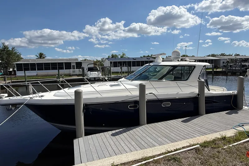 Slide: The Image of 2004 Tiara Yachts 3600 Sovran docked under a sunny sky. - 3