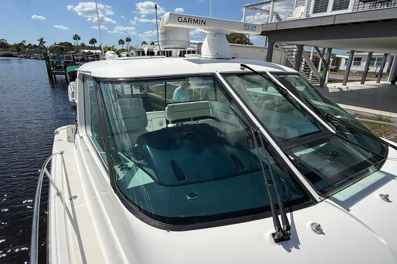 Slide: The Image of 2004 Tiara Yachts 3600 Sovran docked, featuring Garmin radar and sleek design. - 32