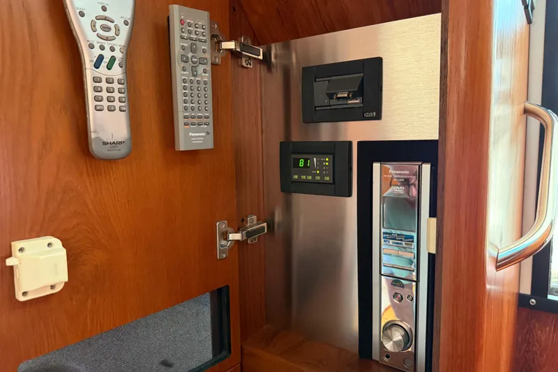 Slide: The Image of Interior electronics panel of 2004 Tiara Yachts 3600 Sovran with remote controls. - 38