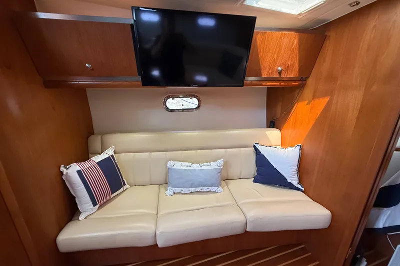 Slide: The Image of Interior of 2004 Tiara Yachts 3600 Sovran with beige sofa and decorative pillows. - 48