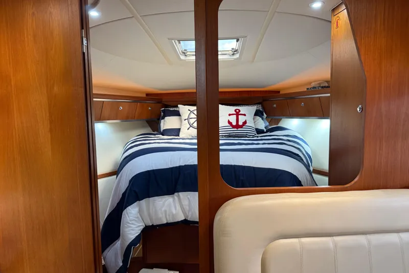 Slide: The Image of Luxurious cabin interior of 2004 Tiara Yachts 3600 Sovran with nautical-themed bedding. - 50