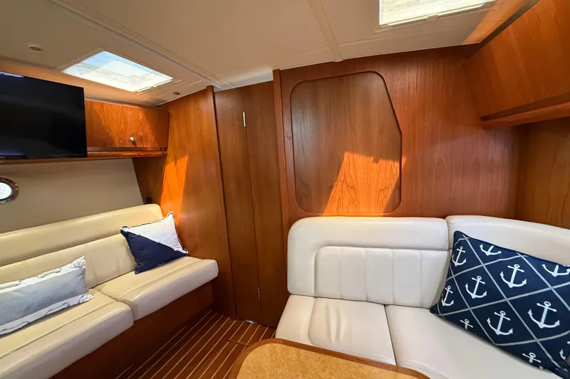 Slide: The Image of Luxurious interior of 2004 Tiara Yachts 3600 Sovran with elegant wood finish and plush seating. - 51