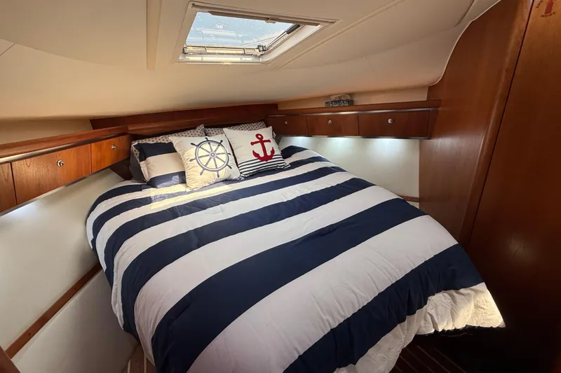 Slide: The Image of Luxurious cabin interior of 2004 Tiara Yachts 3600 Sovran with nautical-themed bedding. - 55
