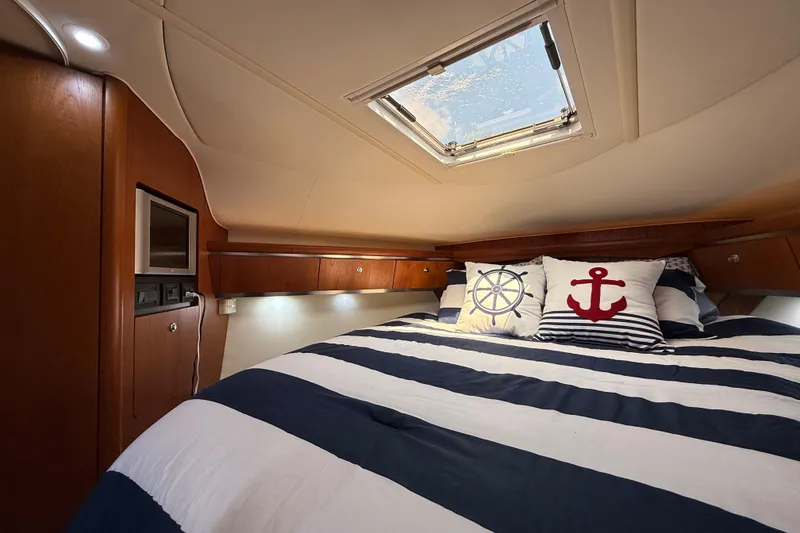 Slide: The Image of Luxurious cabin interior of 2004 Tiara Yachts 3600 Sovran with nautical-themed bedding. - 56