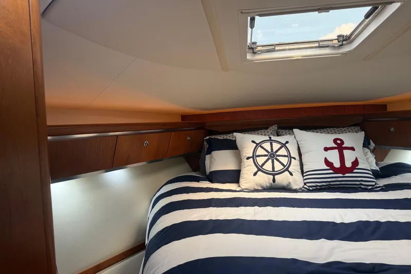 Slide: The Image of Cozy cabin interior of 2004 Tiara Yachts 3600 Sovran with nautical-themed bedding. - 57