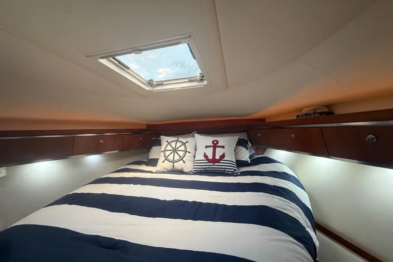 Slide: The Image of Cozy cabin interior of 2004 Tiara Yachts 3600 Sovran with nautical-themed bedding. - 58