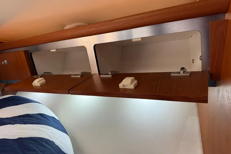 Slide: The Image of Interior storage cabinets on a 2004 Tiara Yachts 3600 Sovran, featuring wooden finish and modern design. - 60