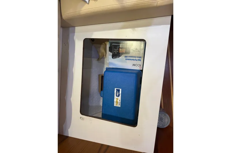 Slide: The Image of Storage compartment on a 2004 Tiara Yachts 3600 Sovran with blue case and equipment. - 65
