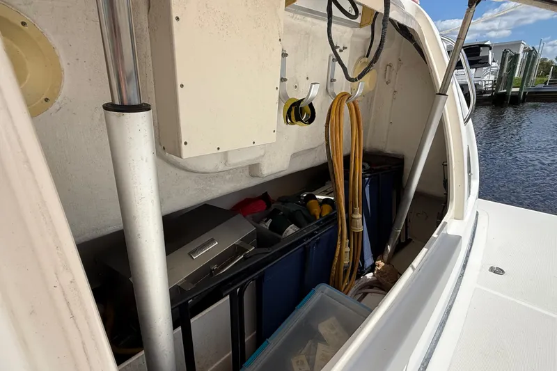 Slide: The Image of Storage compartment on a 2004 Tiara Yachts 3600 Sovran, featuring tools and equipment. - 7