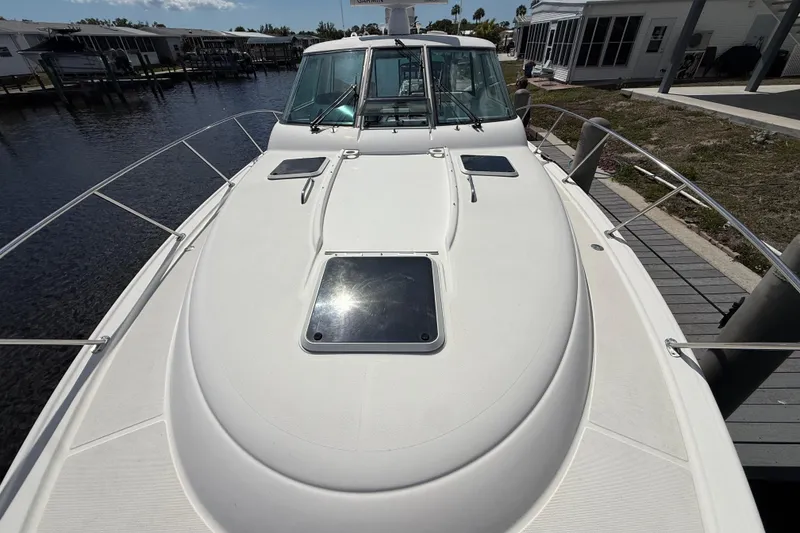 Slide: The Image of 2004 Tiara Yachts 3600 Sovran docked, showcasing sleek deck design and spacious layout. - 8