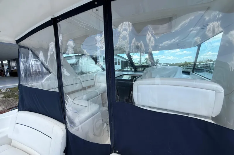 Slide: The Image of 2004 Tiara Yachts 3600 Sovran interior with clear enclosure and white seating. - 9