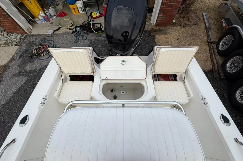 Slide: The Image of 2007 Mako 2201 Tunnel Inshore boat interior with open storage compartments. - 11