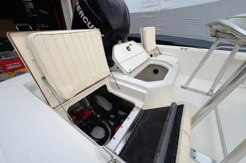 Slide: The Image of 2007 Mako 2201 Tunnel Inshore boat interior with open storage compartments. - 13