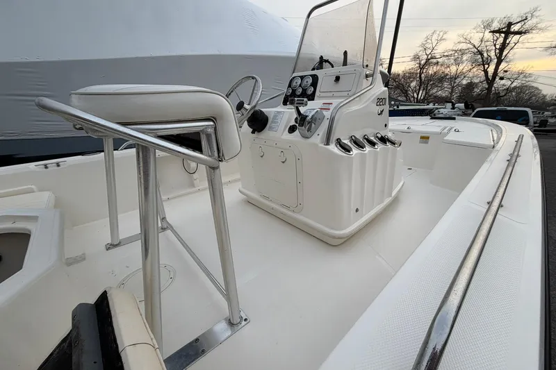 Slide: The Image of 2007 Mako 2201 Tunnel Inshore boat interior with steering console and seating. - 14