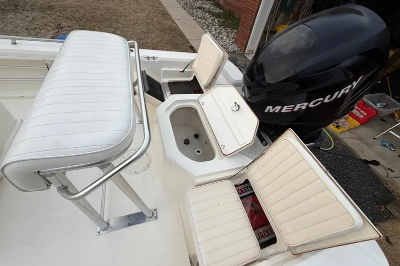 Slide: The Image of 2007 Mako 2201 Tunnel Inshore boat with Mercury engine and white seating. - 16