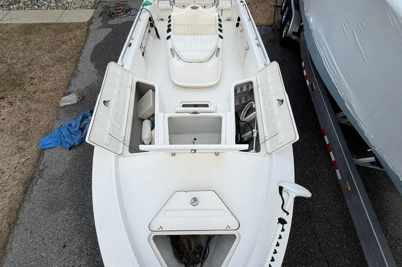 Slide: The Image of 2007 Mako 2201 Tunnel Inshore boat with open storage compartments, viewed from above. - 6