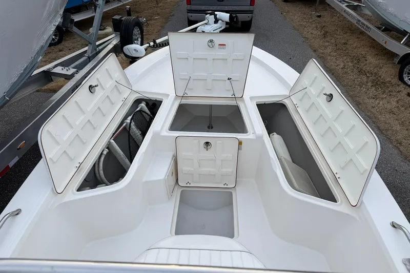 Slide: The Image of 2007 Mako 2201 Tunnel Inshore boat with open storage compartments on deck. - 7