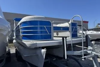 The Image of 2021 Godfrey Sweetwater 2286 C pontoon boat with blue accents on a trailer. - 1