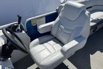 Slide: The Image of Captain's seat of 2021 Godfrey Sweetwater 2286 C pontoon boat, featuring plush white upholstery. - 10