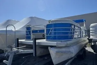 Slide: The Image of 2021 Godfrey Sweetwater 2286 C pontoon boat with blue accents, parked outdoors. - 3