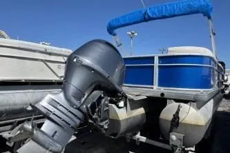 Slide: The Image of 2021 Godfrey Sweetwater 2286 C pontoon boat with blue canopy and outboard motor. - 5