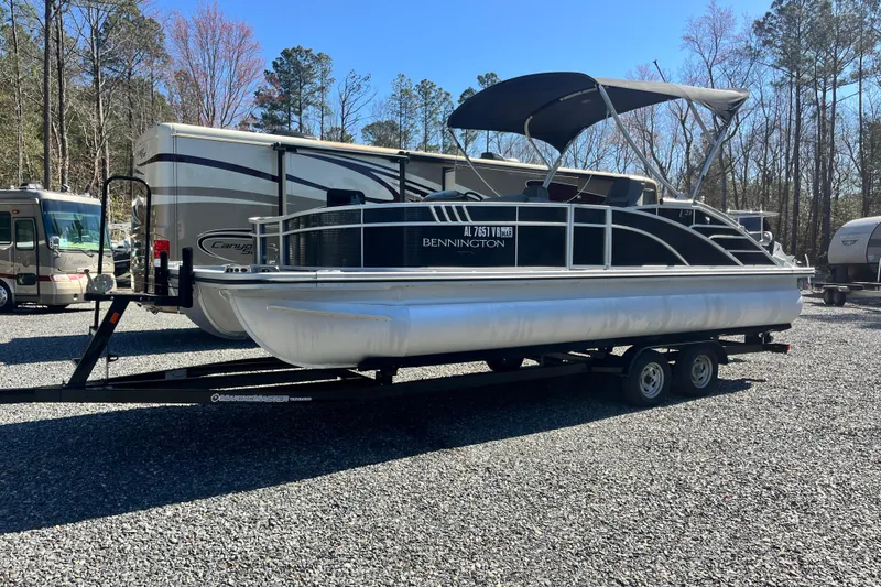 Slide: The Image of 2022 Bennington 23LT pontoon boat on trailer, parked in outdoor lot. - 3