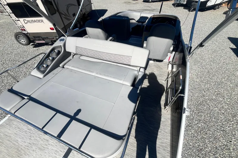 Slide: The Image of 2022 Bennington 23LT pontoon boat with spacious seating and modern design. - 6