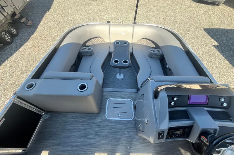 Slide: The Image of 2022 Bennington 23LT boat interior with gray seating and modern dashboard. - 8