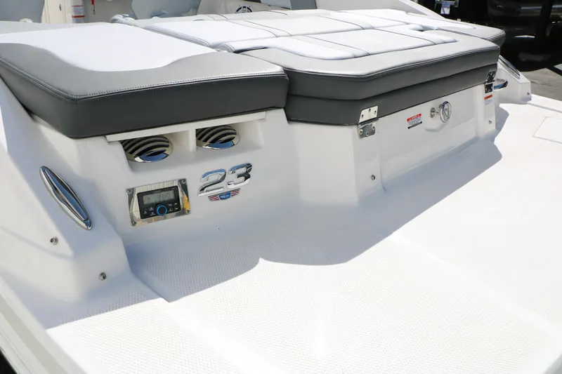 Slide: The Image of 2026 Chaparral 23 SSi boat deck with cushioned seating and control panel. - 10