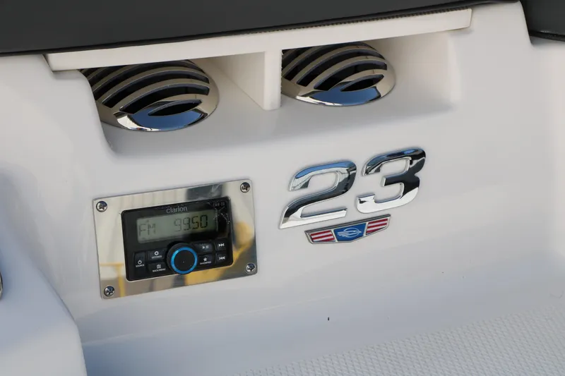 Slide: The Image of 2026 Chaparral 23 SSi boat dashboard with radio and chrome details. - 11