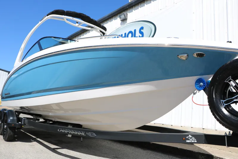 Slide: The Image of 2026 Chaparral 23 SSi boat on trailer, blue and white design, outdoor display. - 14