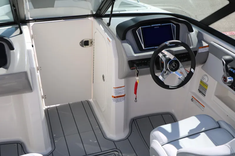 Slide: The Image of Interior view of 2026 Chaparral 23 SSi boat cockpit with steering wheel and controls. - 31