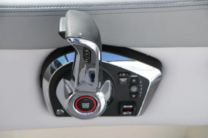Slide: The Image of 2026 Chaparral 23 SSi boat throttle control with start-stop button and trim adjustment. - 37