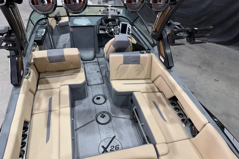Slide: The Image of 2022 MasterCraft X26 boat interior with beige seating and modern dashboard. - 5