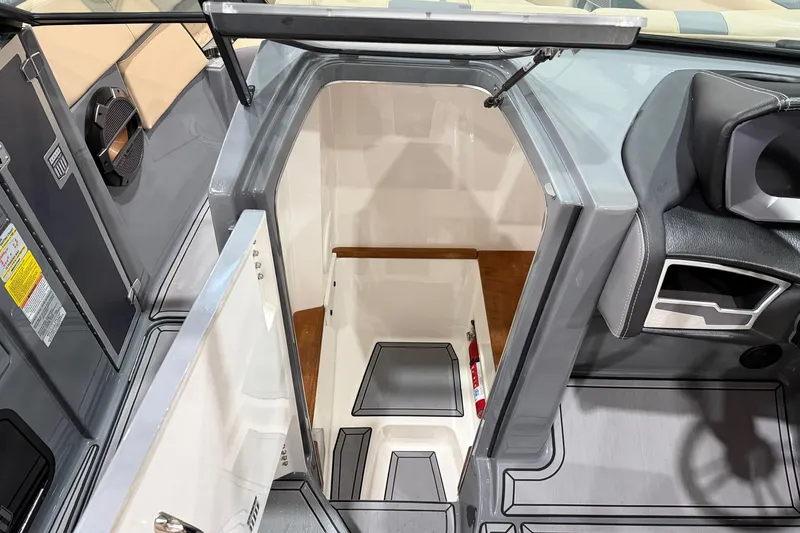 Slide: The Image of 2022 MasterCraft X26 boat interior with open hatch and seating area. - 9