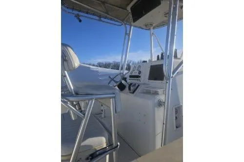 Slide: The Image of 2004 Sea Pro 220 Center Console boat interior with steering and controls. - 10