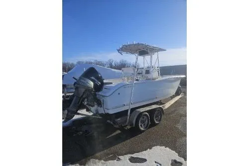 Slide: The Image of 2004 Sea Pro 220 Center Console boat on trailer under clear blue sky. - 4