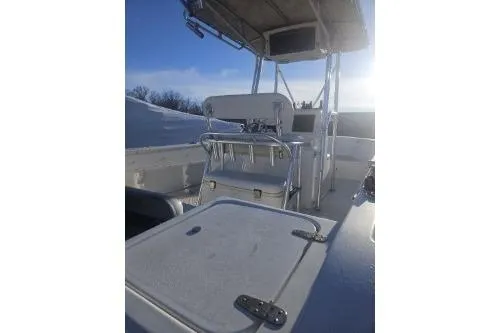 Slide: The Image of 2004 Sea Pro 220 Center Console boat with seating and storage, under a clear sky. - 5